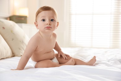 Photo of Cute little baby on bed at home