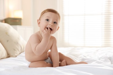 Photo of Cute little baby on bed at home