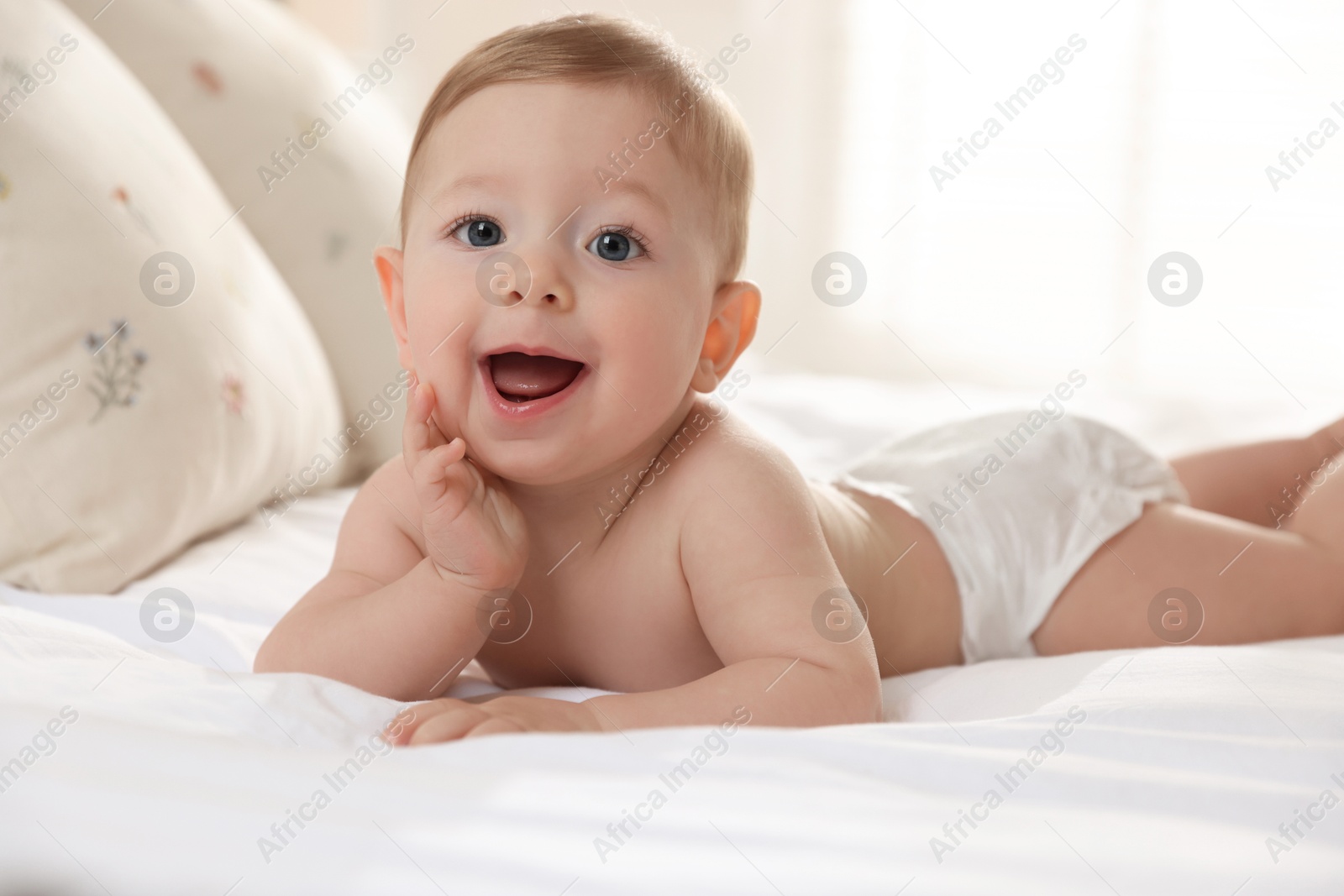 Photo of Cute little baby on bed at home