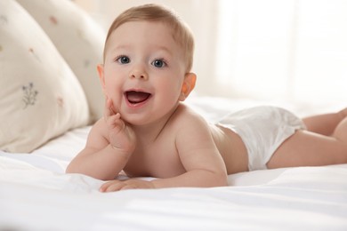 Photo of Cute little baby on bed at home