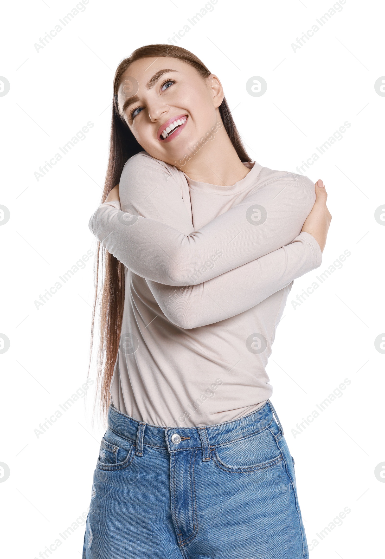 Photo of Charming young woman hugging herself on white background