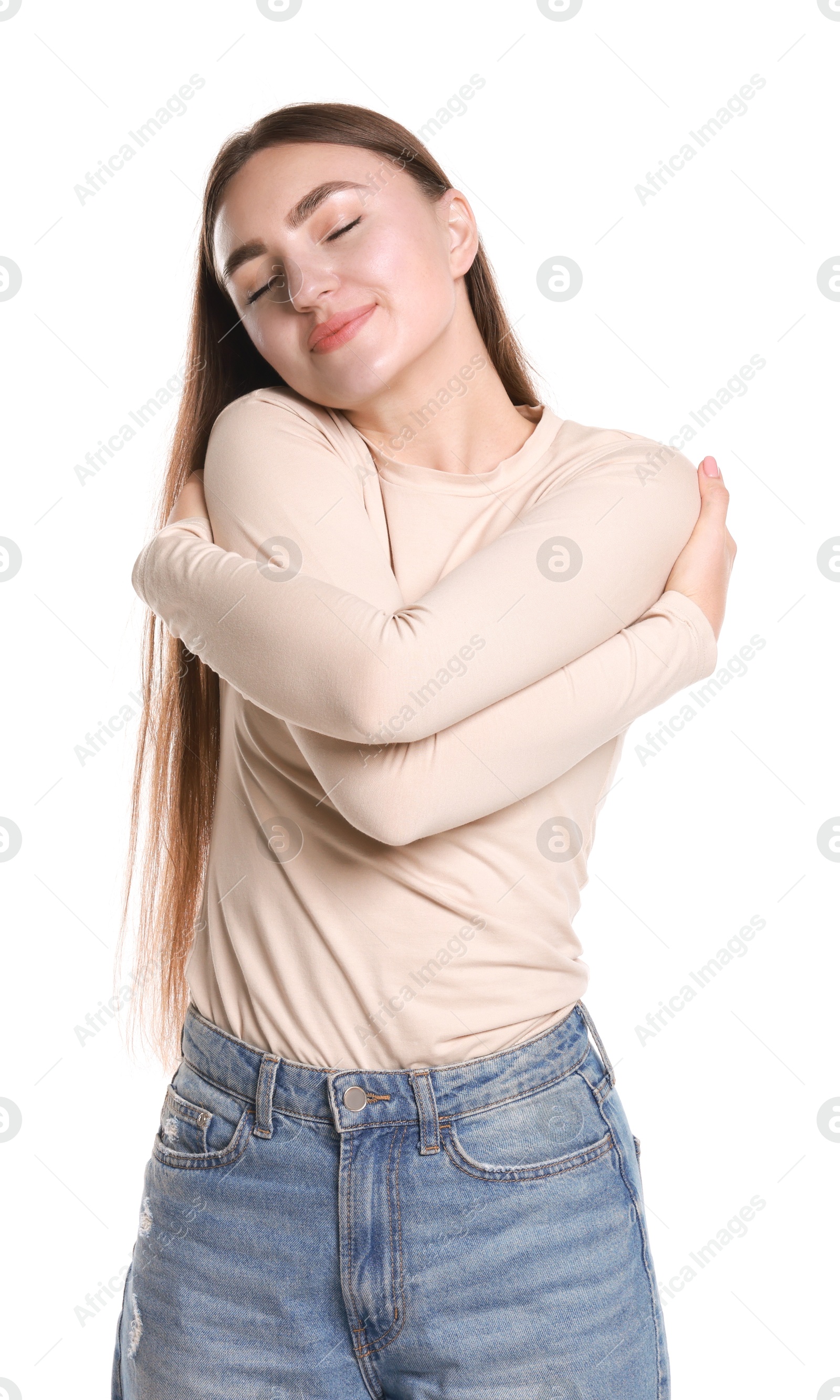 Photo of Charming young woman hugging herself on white background