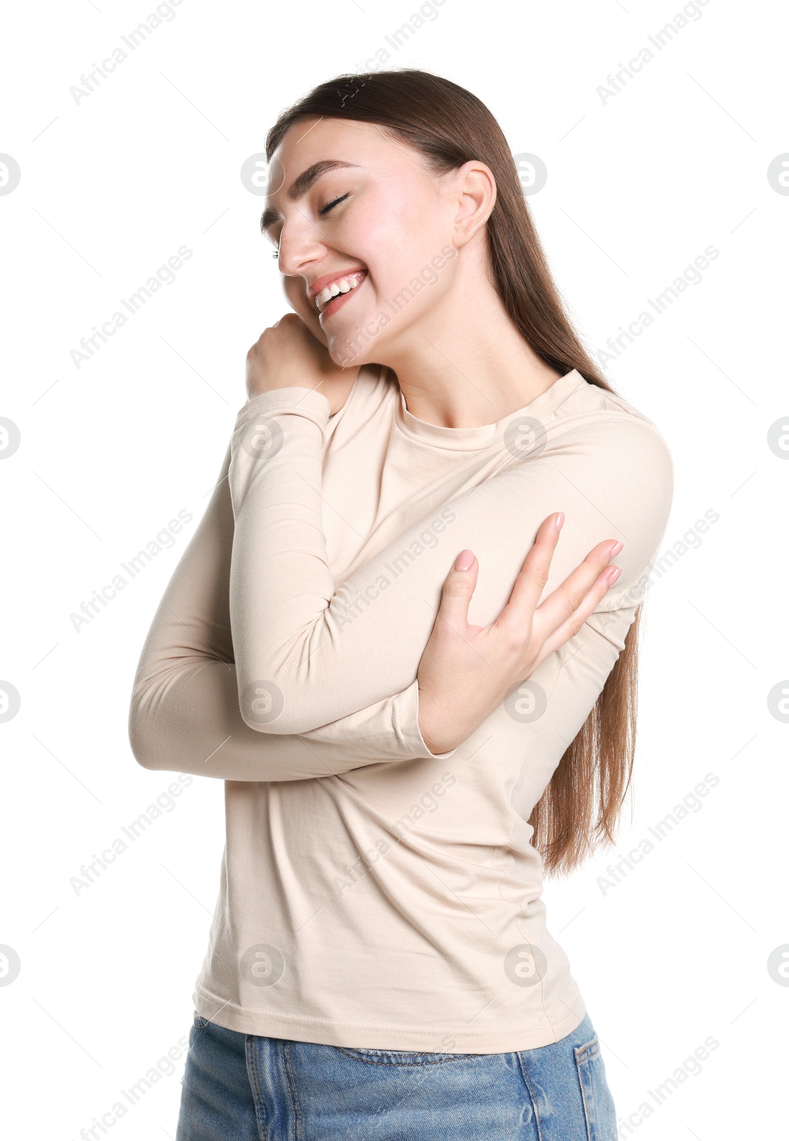 Photo of Charming young woman hugging herself on white background