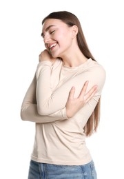 Photo of Charming young woman hugging herself on white background