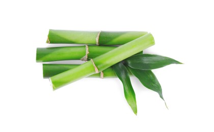 Photo of Pieces of decorative bamboo plant and green leaves isolated on white, top view