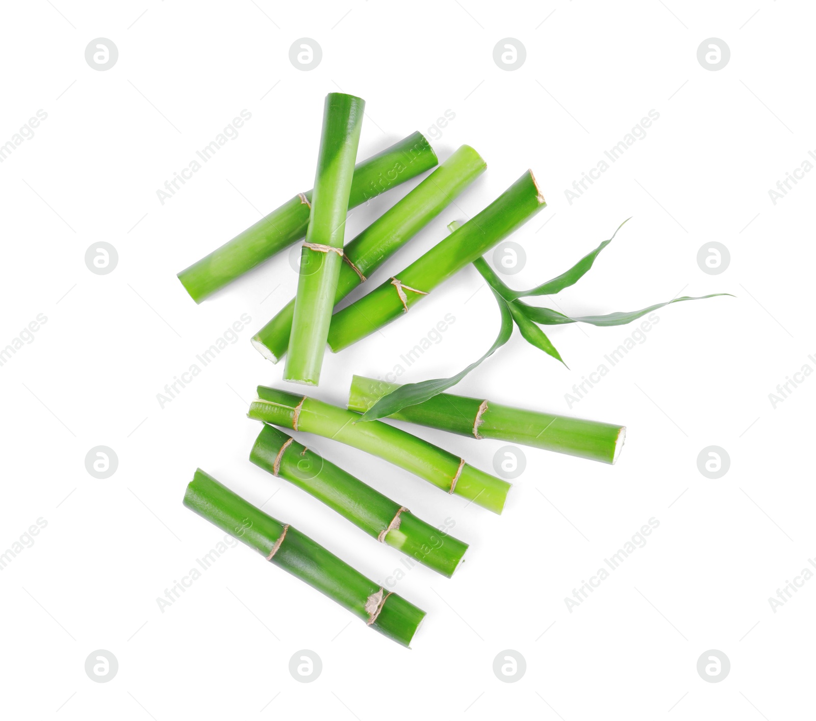 Photo of Pieces of decorative bamboo plant and green leaves isolated on white, top view