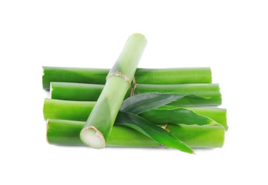 Pieces of decorative bamboo plant and green leaves isolated on white