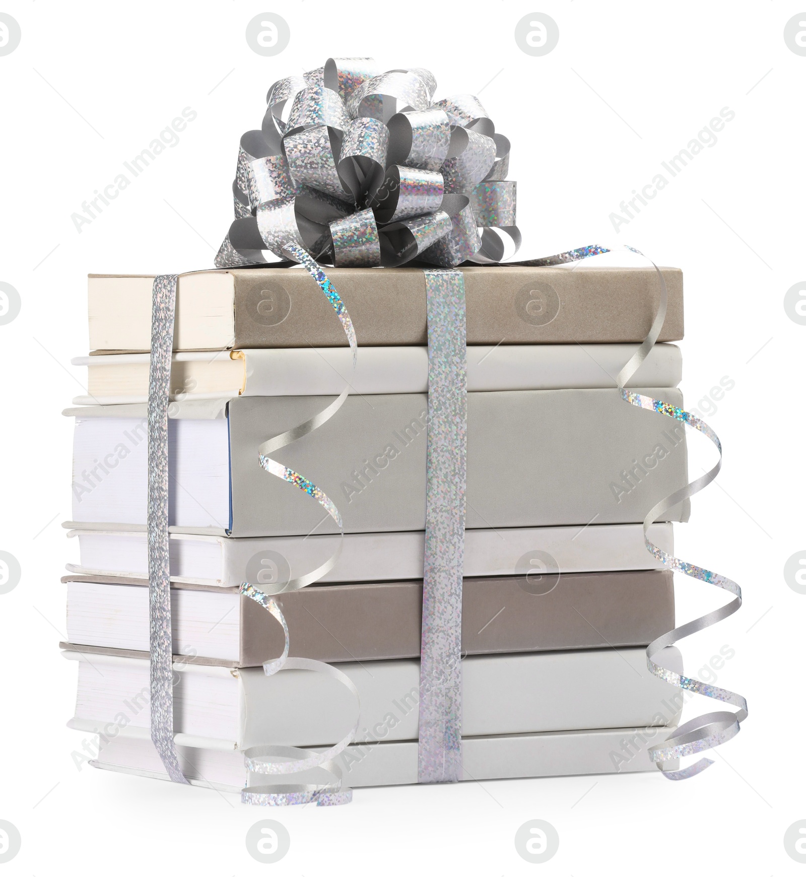 Photo of Stack of books with silver bow as gift isolated on white