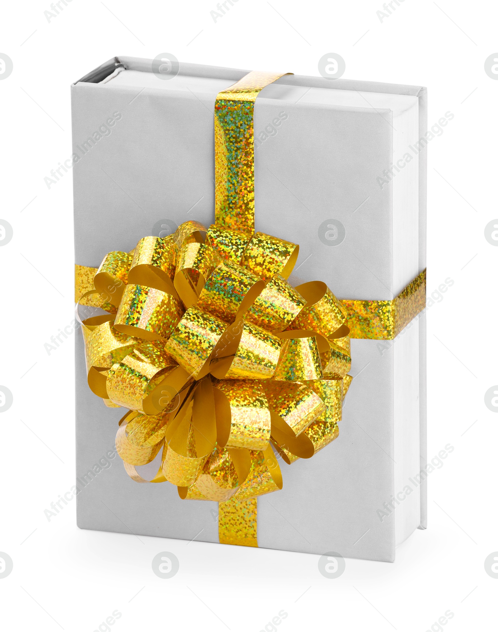 Photo of One book with golden bow as gift isolated on white