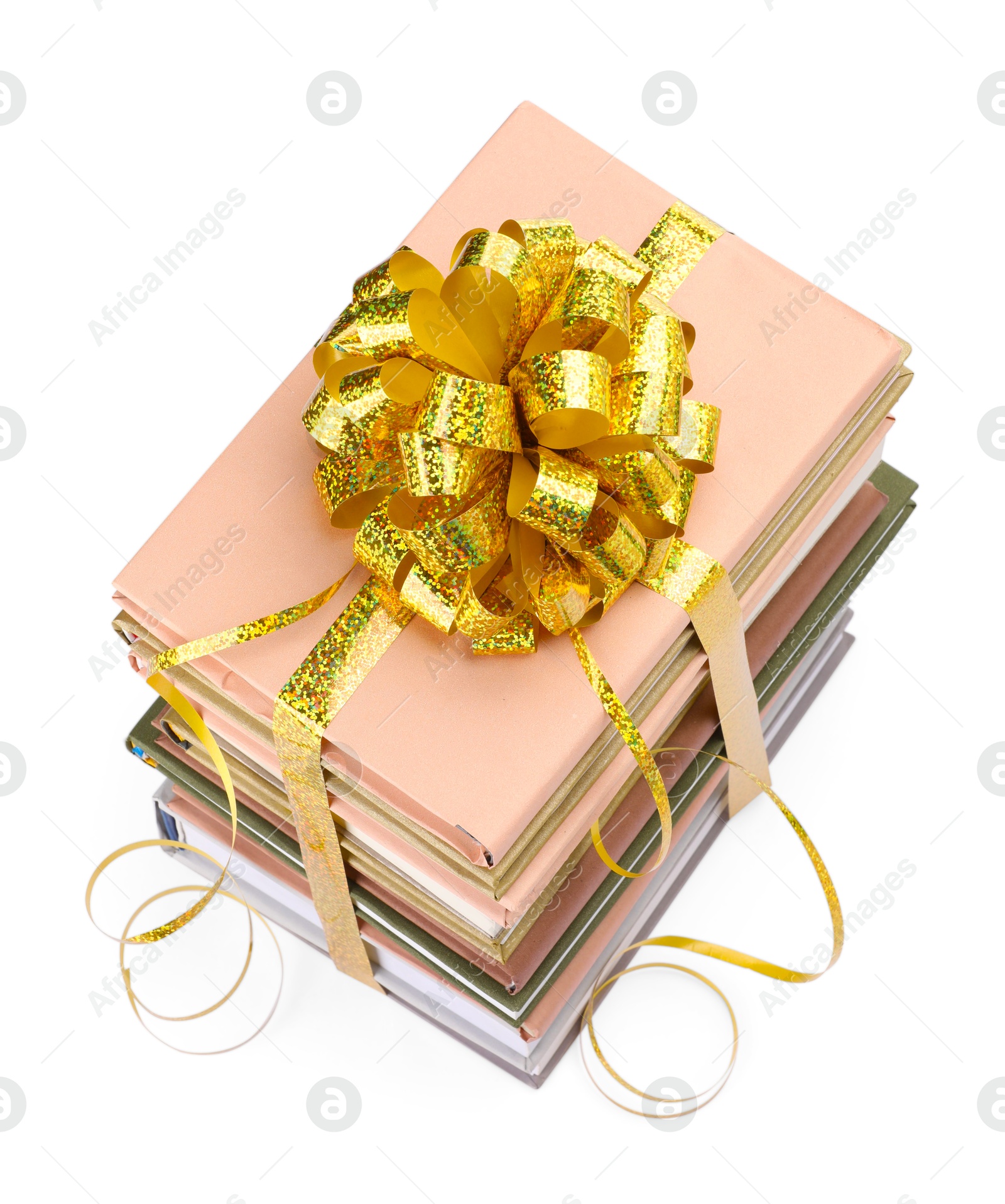 Photo of Stack of books with golden bow as gift isolated on white