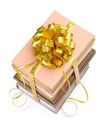 Photo of Stack of books with golden bow as gift isolated on white