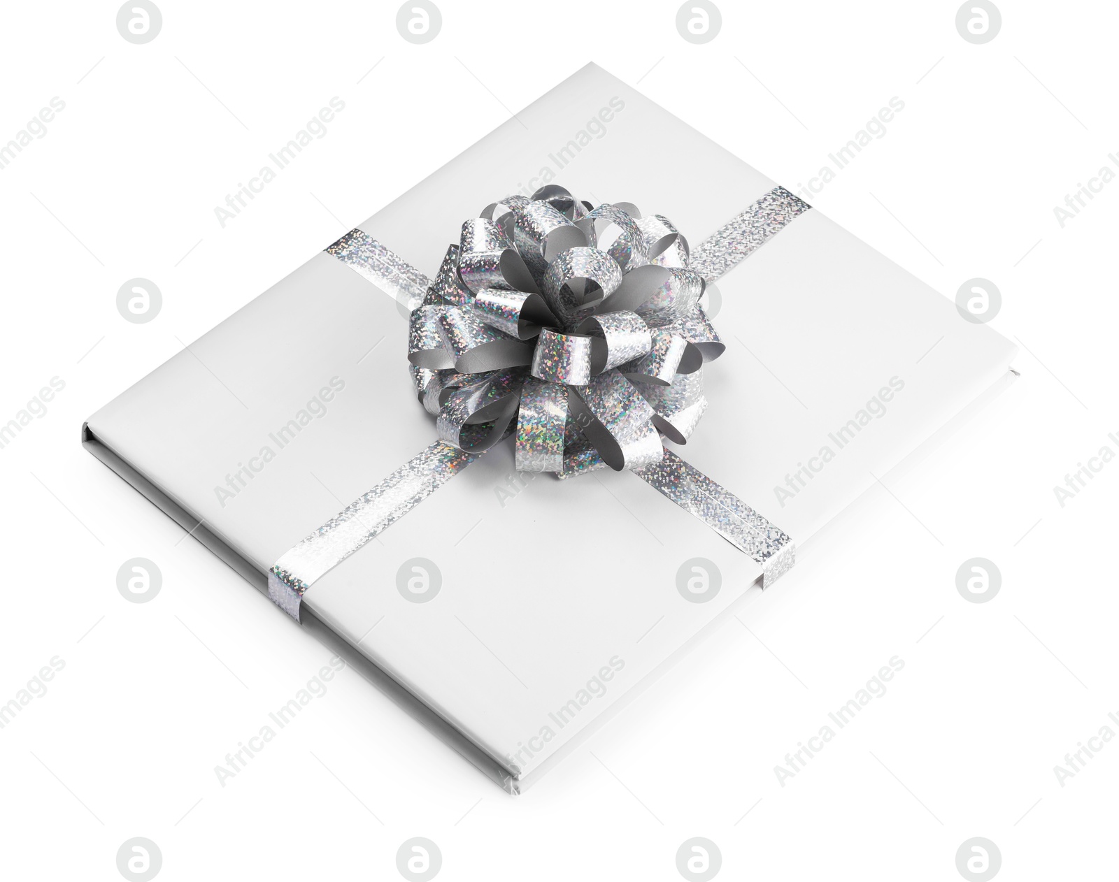 Photo of One book with silver bow as gift isolated on white