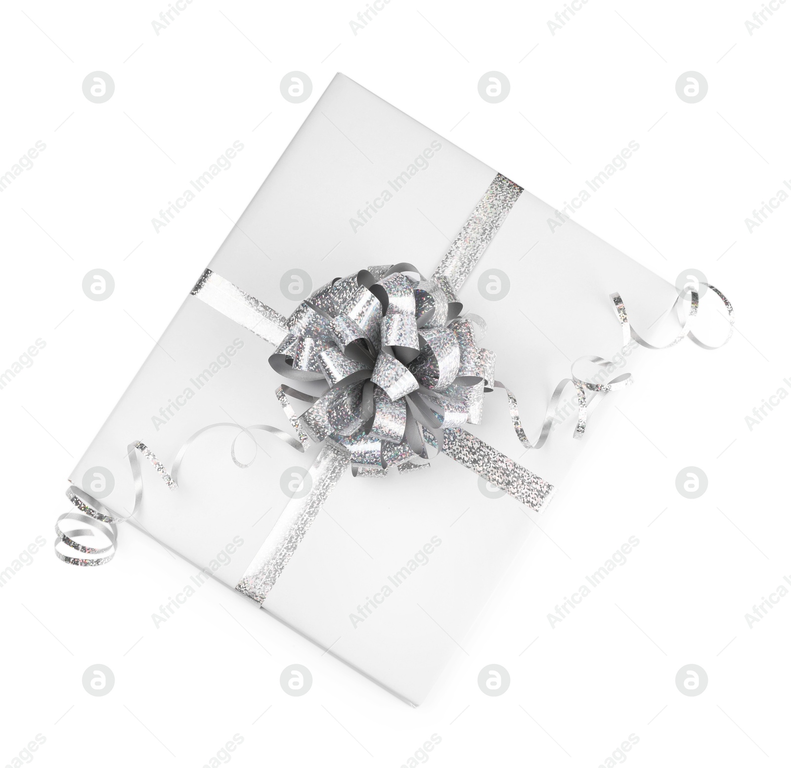 Photo of One book with silver bow as gift isolated on white, top view