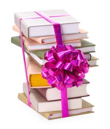 Photo of Stack of books with purple bow as gift isolated on white