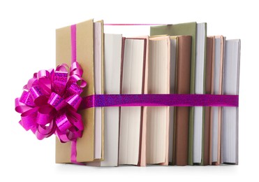 Photo of Books with purple bow as gift isolated on white