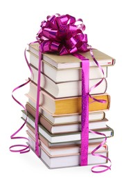 Photo of Stack of books with purple bow as gift isolated on white