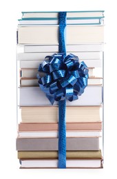 Photo of Stack of books with blue bow as gift isolated on white