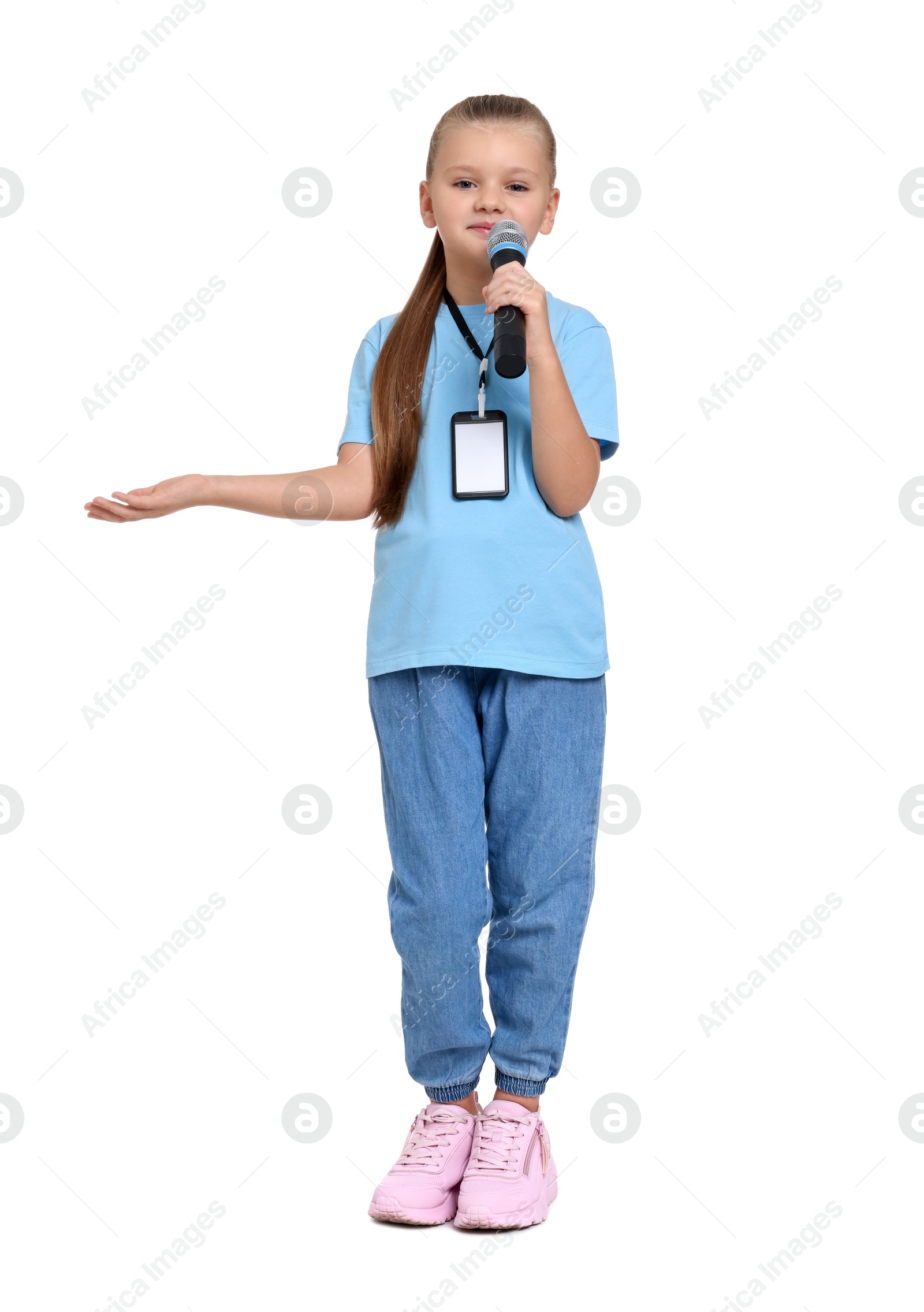 Photo of Little girl with microphone pretending to be journalist on white background. Dreaming of future profession