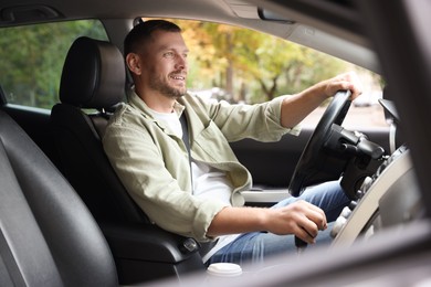 Photo of Man driving modern car, view through window