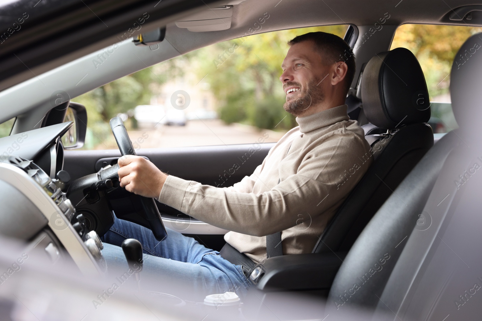 Photo of Man driving modern car, view through window