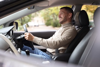 Photo of Man driving modern car, view through window