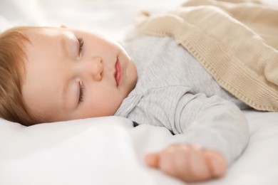 Photo of Cute little baby sleeping on bed at home