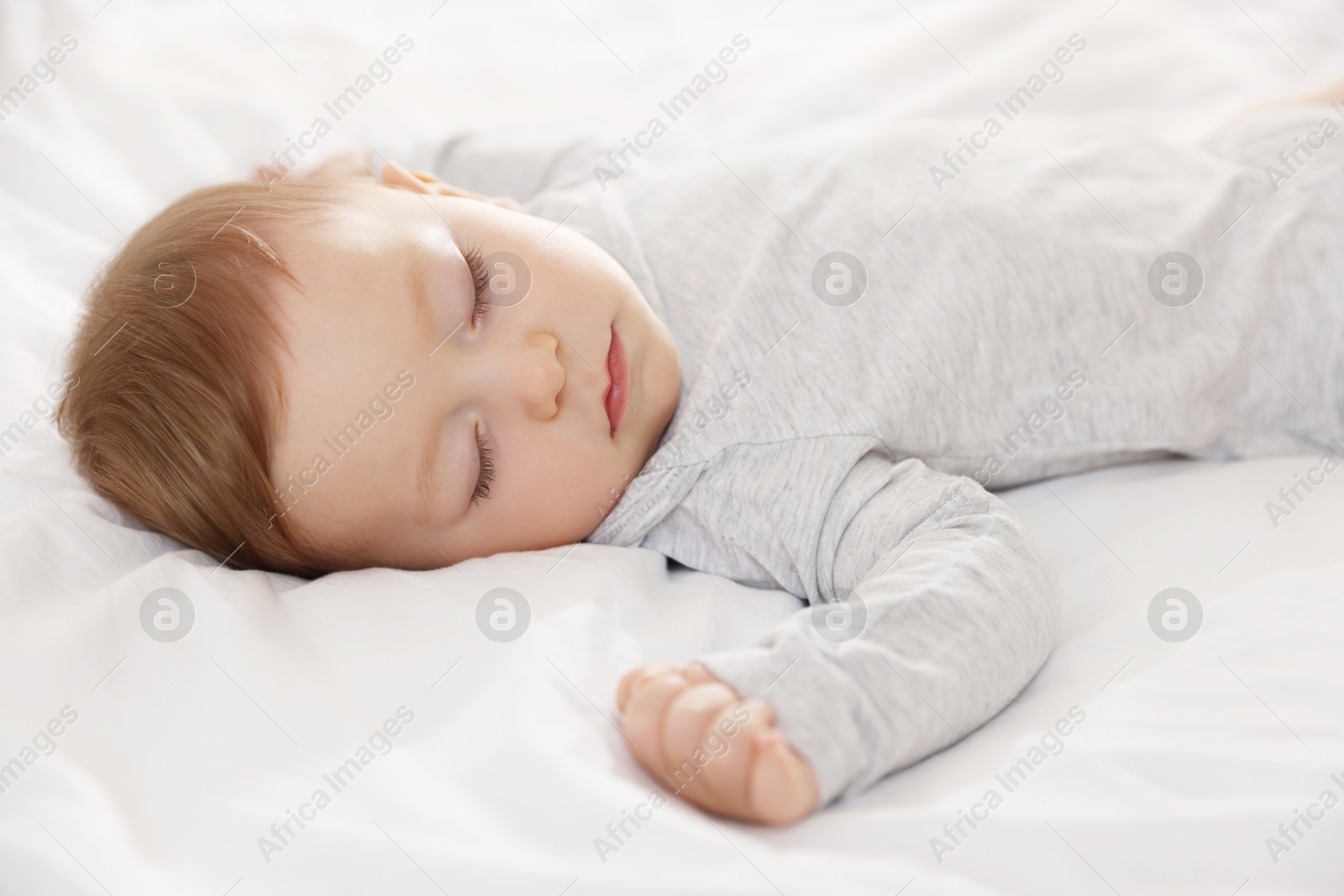 Photo of Cute little baby sleeping on bed at home