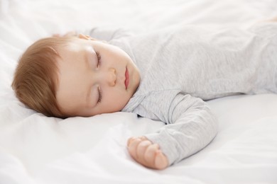 Photo of Cute little baby sleeping on bed at home