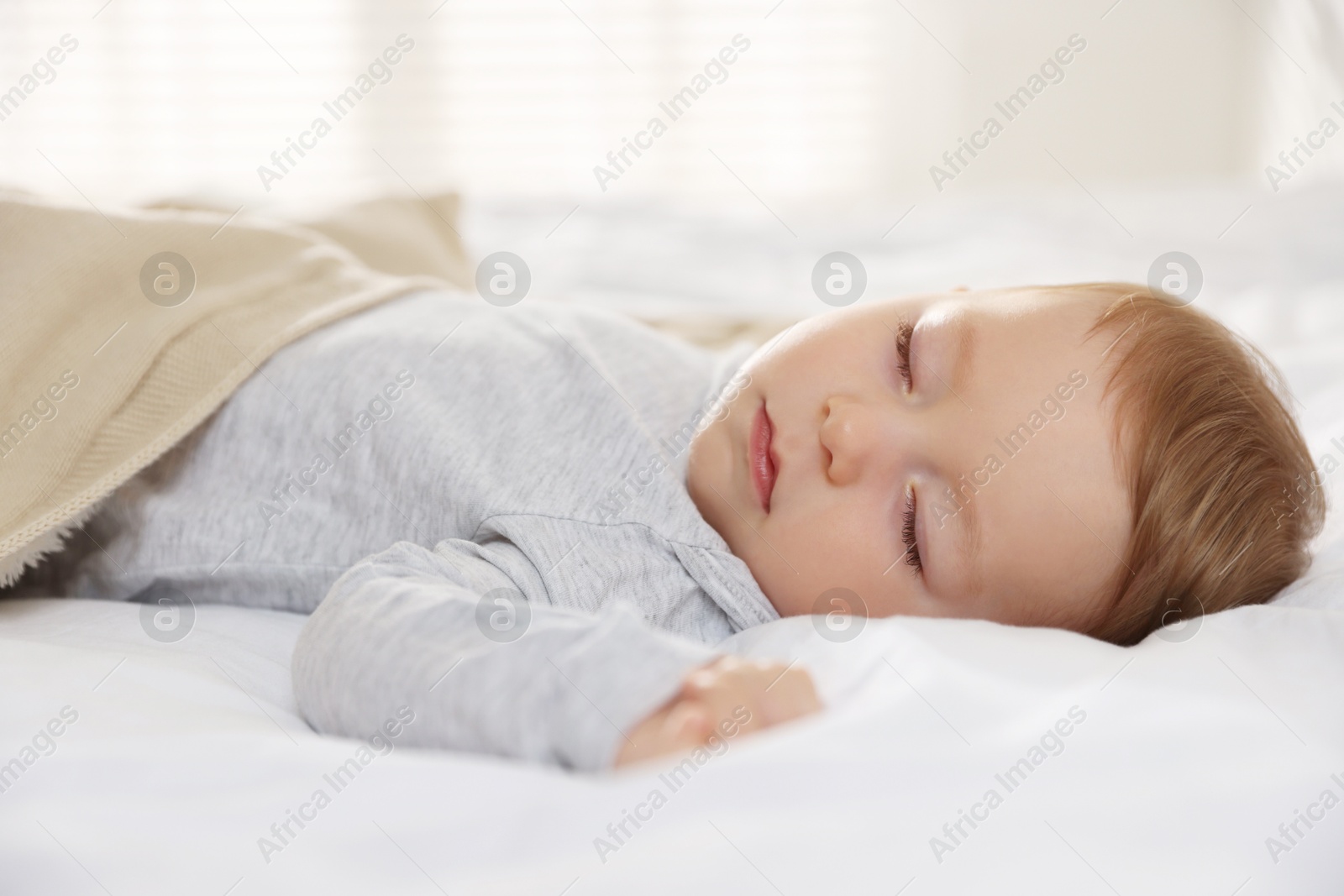 Photo of Cute little baby sleeping on bed at home