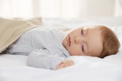 Photo of Cute little baby sleeping on bed at home