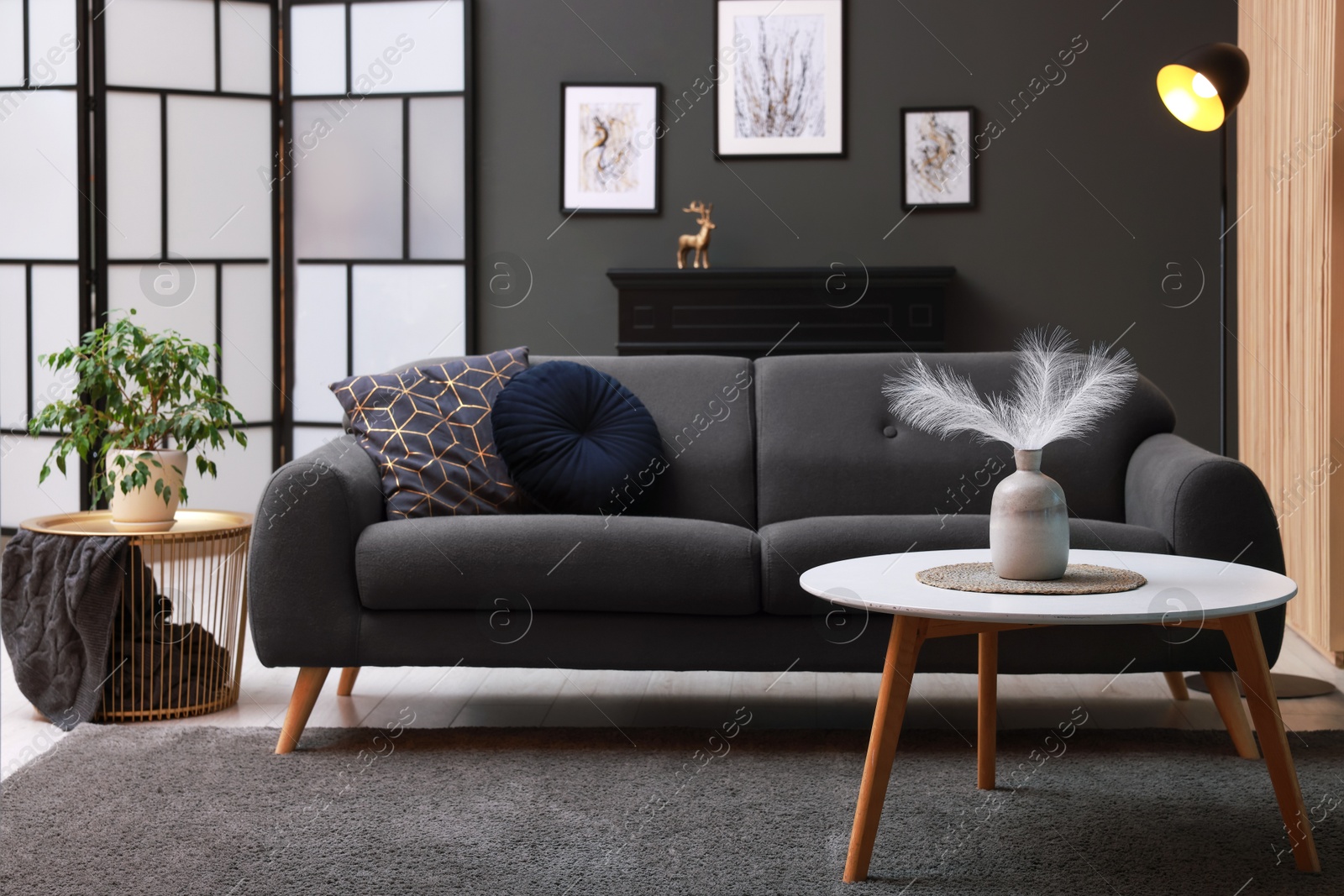 Photo of Stylish living room interior with comfortable sofa near grey wall