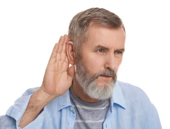 Photo of Senior man showing hand to ear gesture on white background