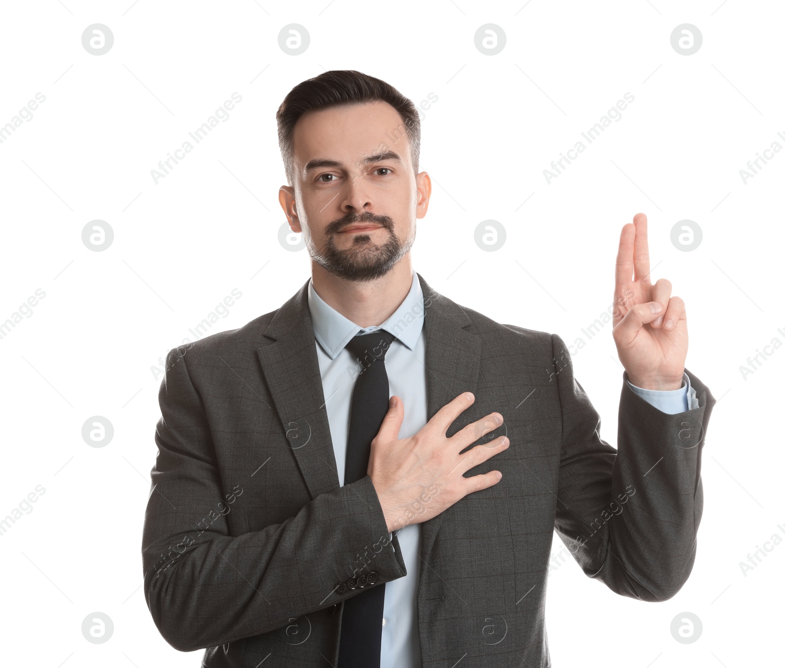 Photo of Man showing oath gesture on white background. Making promise