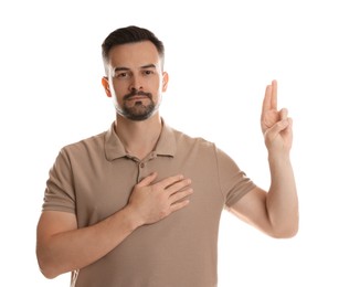 Photo of Man showing oath gesture on white background. Making promise