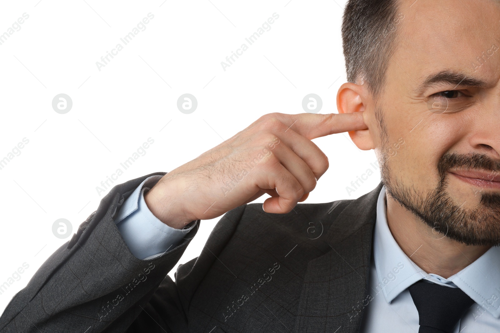 Photo of Man covering his ear with finger on white background, closeup