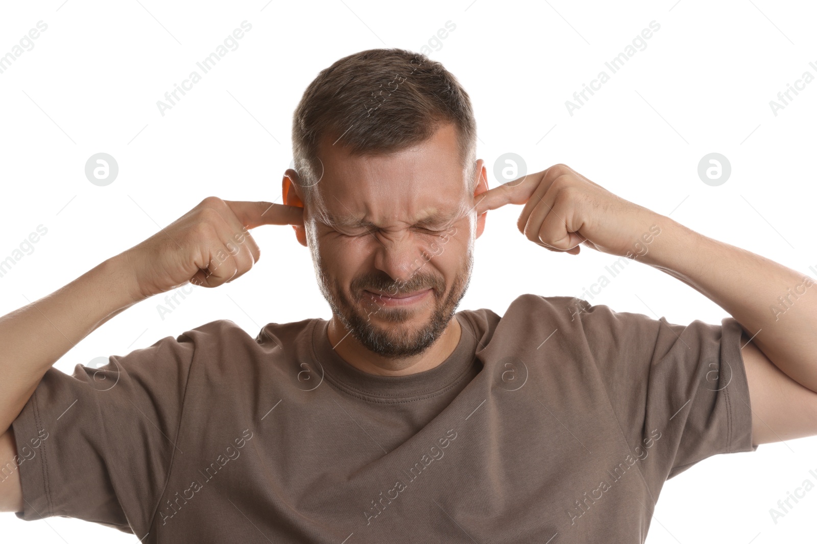 Photo of Man covering his ears with fingers on white background