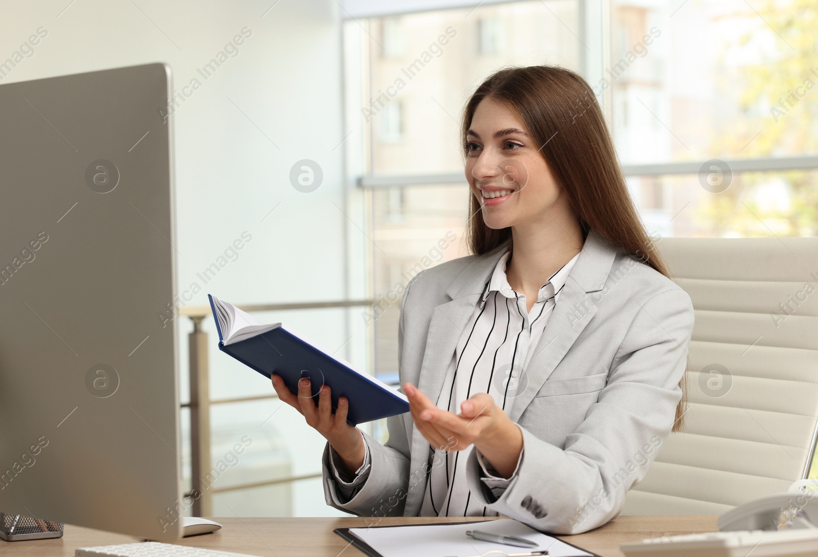 Photo of Banker with notebook working at table in office