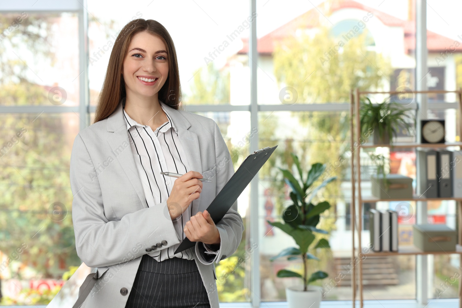 Photo of Portrait of banker with clipboard in office. Space for text