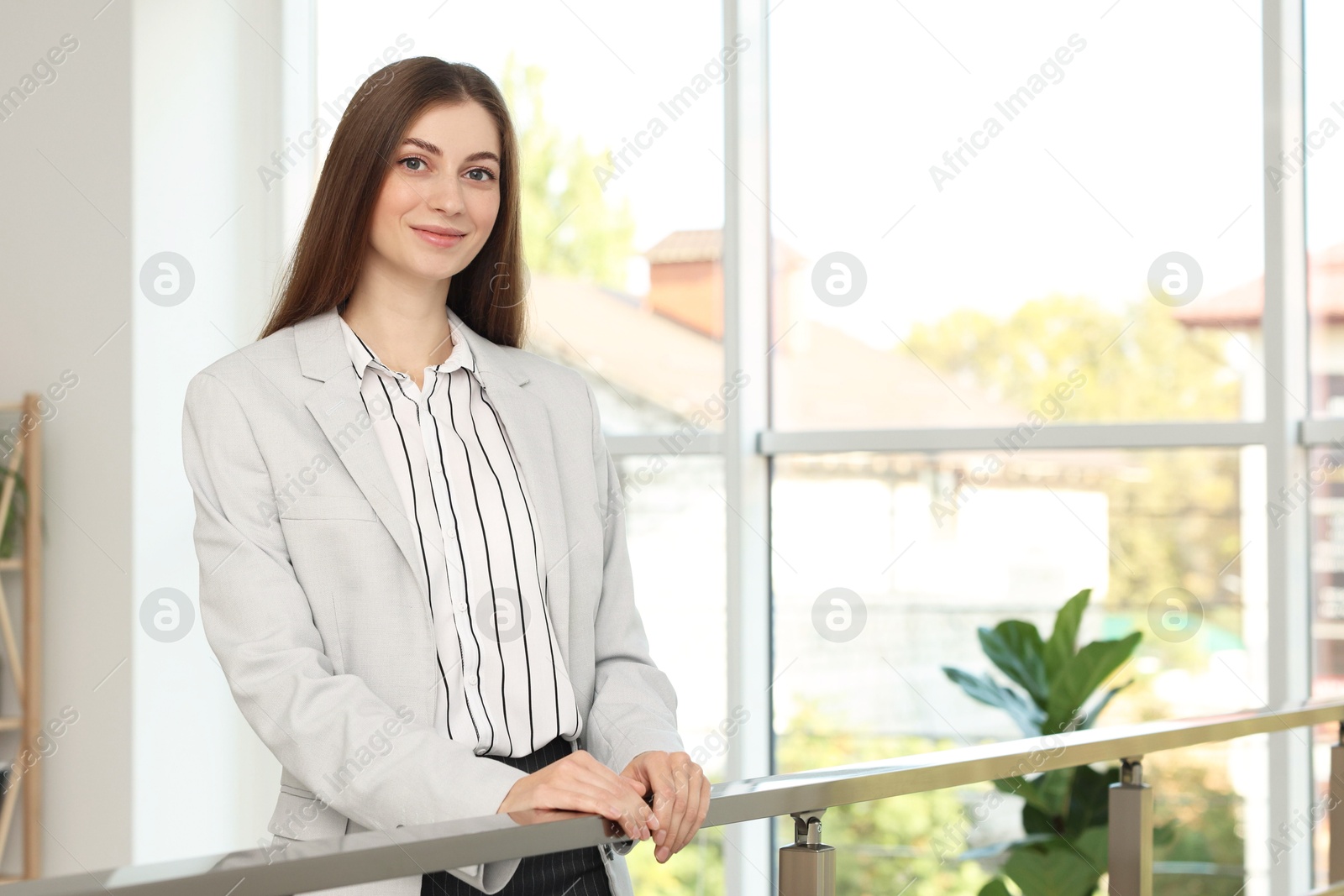 Photo of Portrait of happy banker in jacket indoors. Space for text