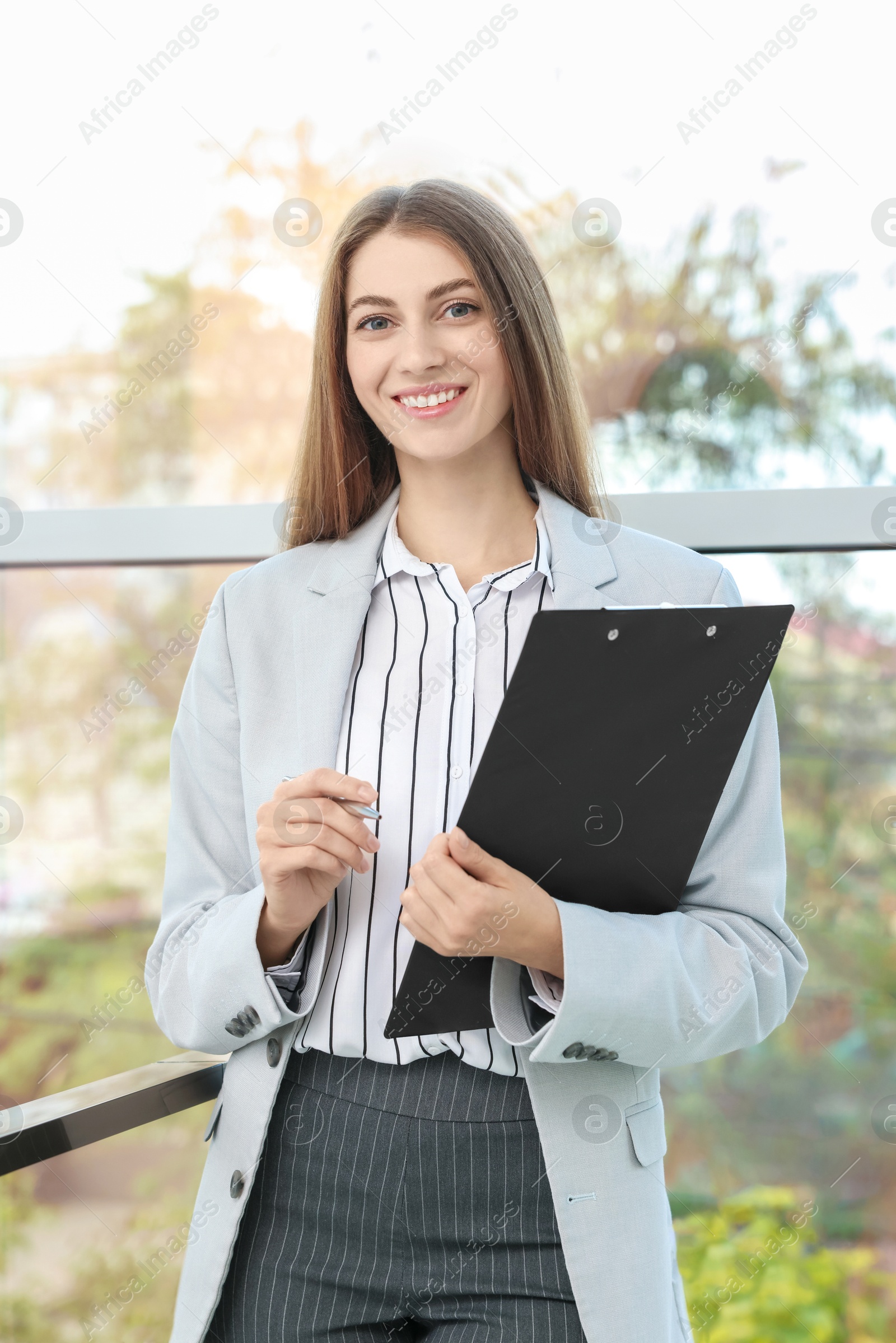 Photo of Portrait of banker with clipboard in office