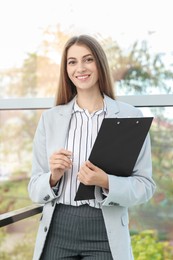 Photo of Portrait of banker with clipboard in office