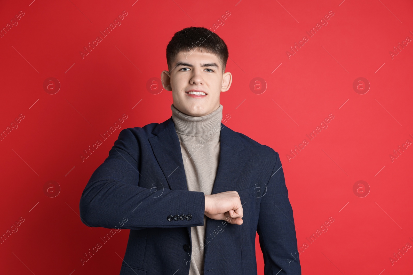 Photo of Man making promise on red background. Oath gesture