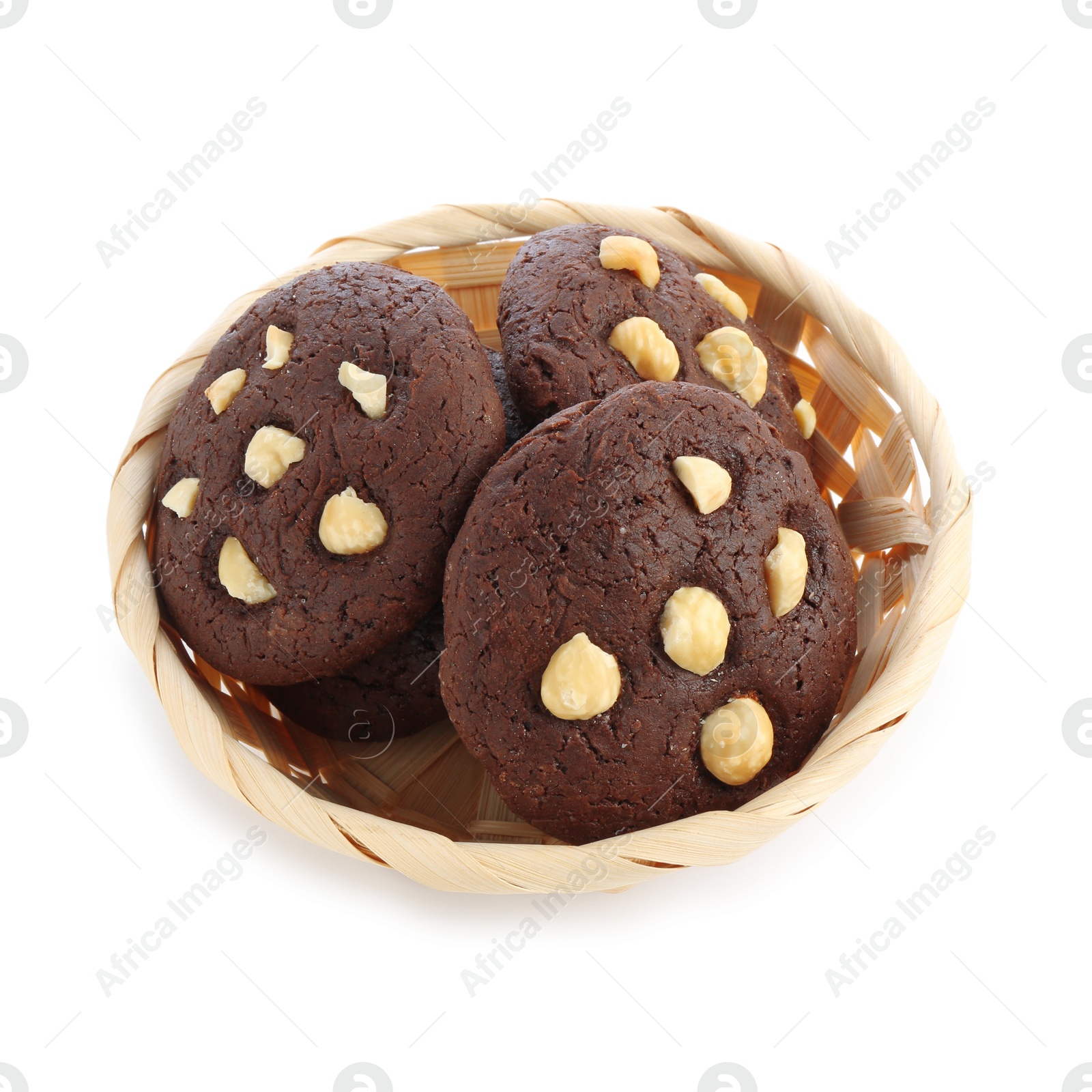 Photo of Tasty chocolate cookies with hazelnuts in wicker basket isolated on white