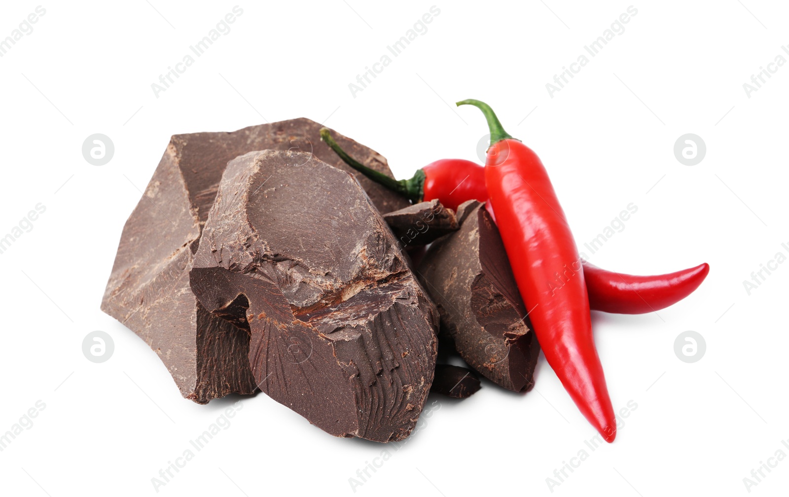 Photo of Pieces of tasty chocolate with chili peppers isolated on white