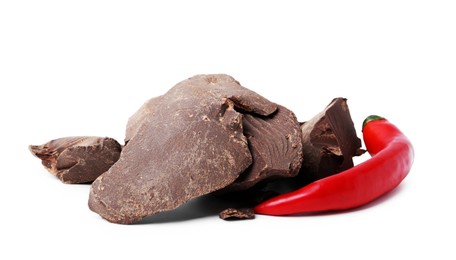 Photo of Pieces of tasty chocolate with chili pepper isolated on white