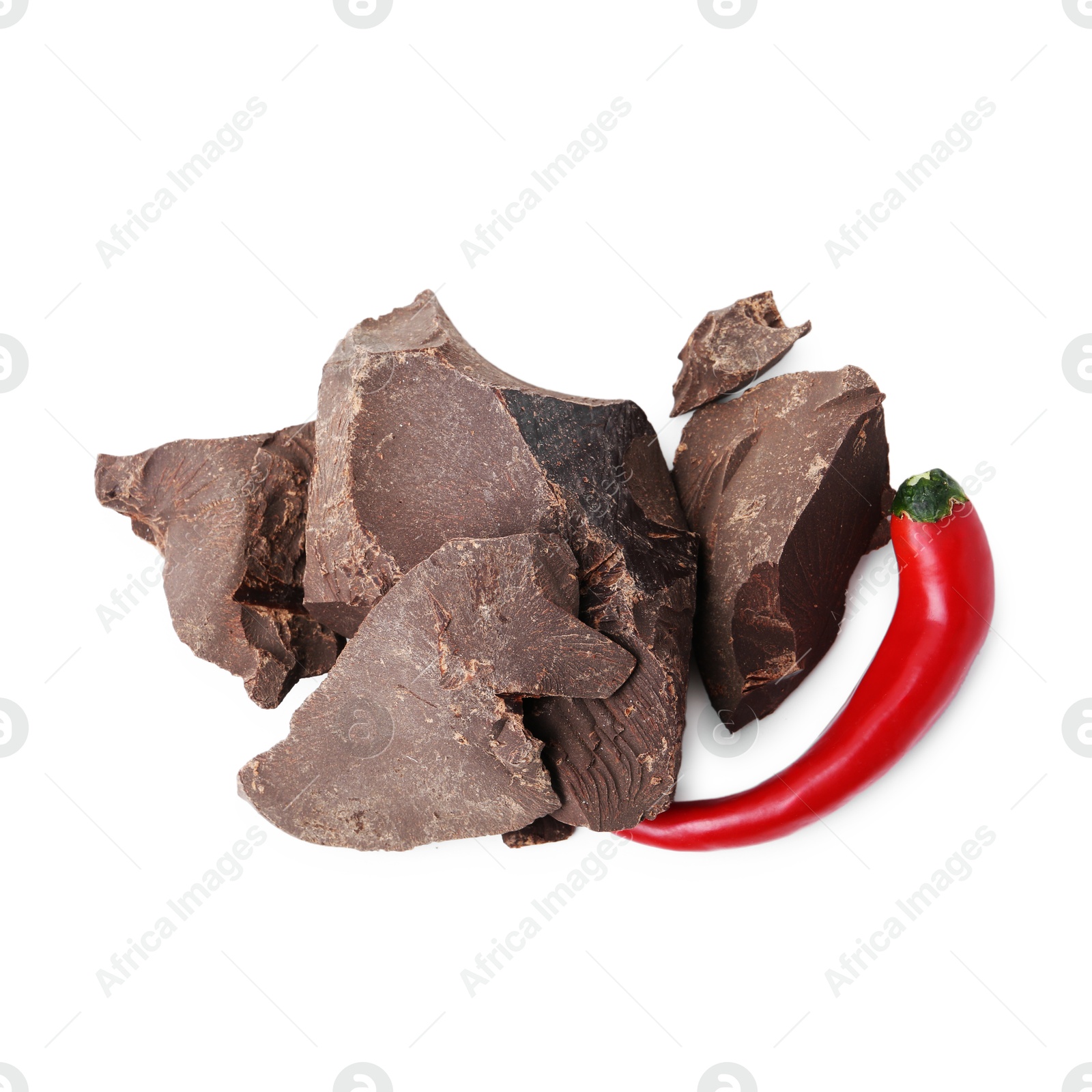 Photo of Pieces of tasty chocolate with chili pepper isolated on white, top view