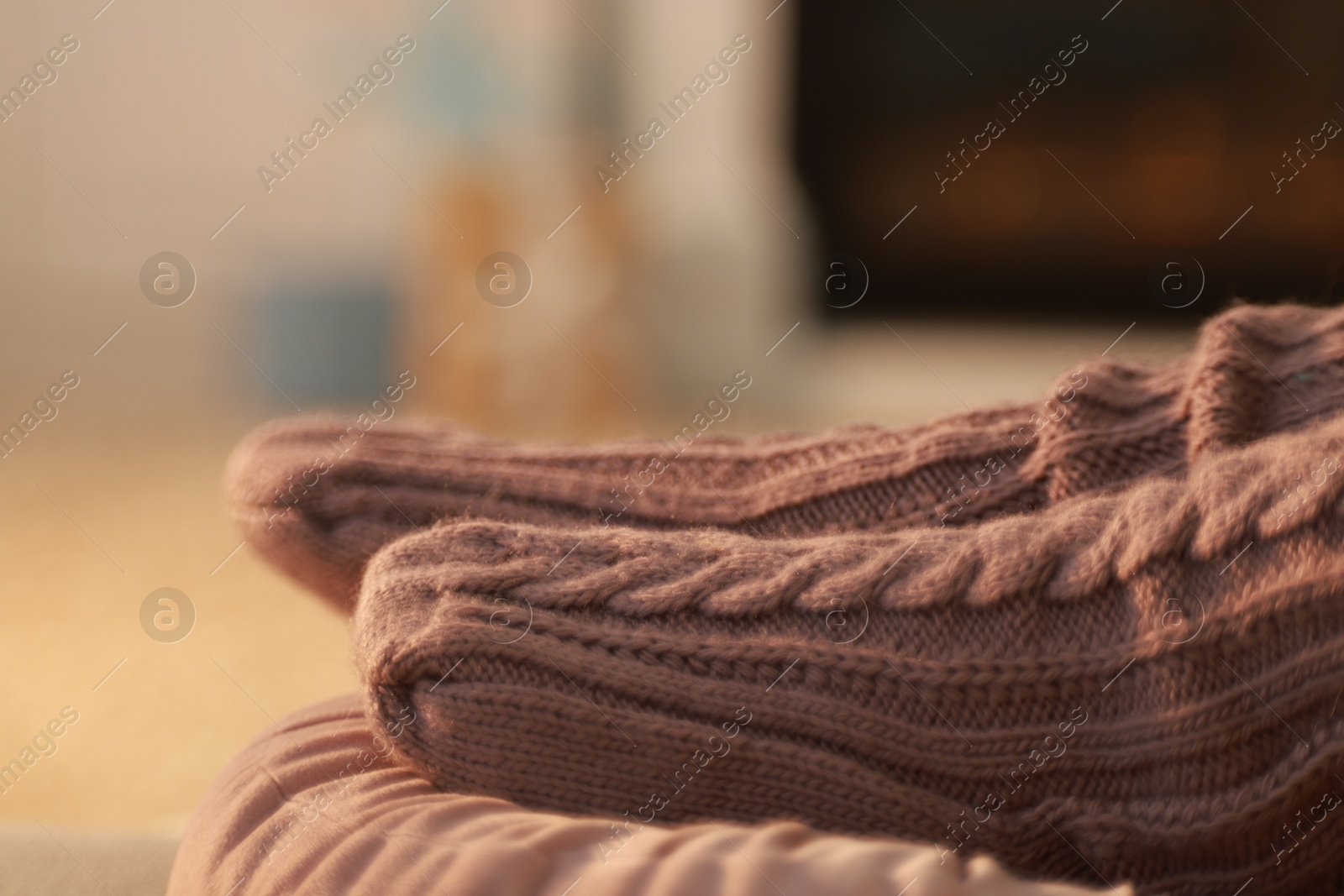 Photo of Woman in knitted socks resting at home, closeup