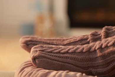 Photo of Woman in knitted socks resting at home, closeup