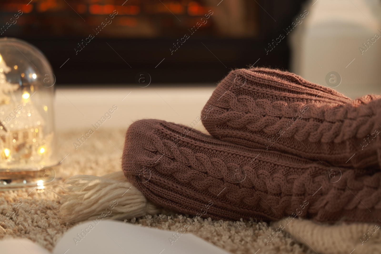 Photo of Woman in knitted socks resting at home, closeup