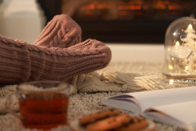 Woman in knitted socks resting at home, closeup